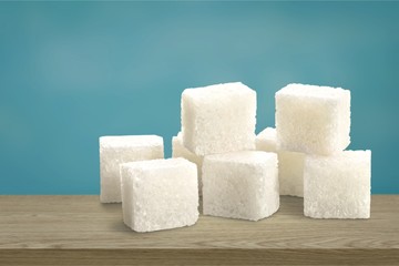 Cubes of sugar on white background