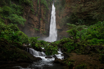 Fototapeta na wymiar Beautiful Kapas Biru waterfall in Java, Indonesia