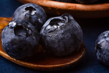 bog whortleberry in a wooden spoon. macro photography