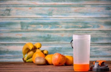 Fruits and Vegetables are blended up into a healthy smoothie and in the process of pouring into a sports glass for fitness.