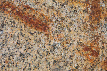 The texture ocher granite slab with a strip of rust on the diagonal