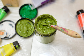 Jar and tubes of paint