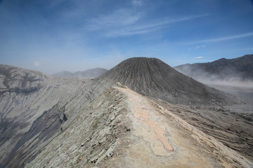 Insane landscape of the Mount Bromo crater rim, Mount Batok, and a dust storm in the Sea to Sands in East Java, Indonesia