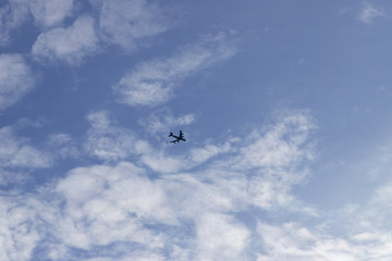 Airplane in the cloudy sky