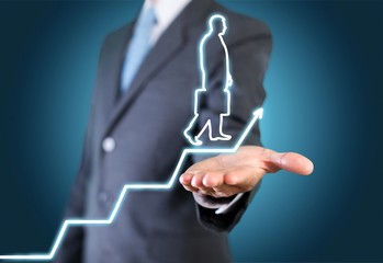 Fototapeta premium Businessman holding digital glowing graph with silhouette