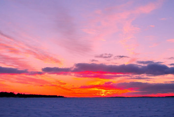 Naklejka na ściany i meble Winter sunset over frozen Baltic Sea in Finland