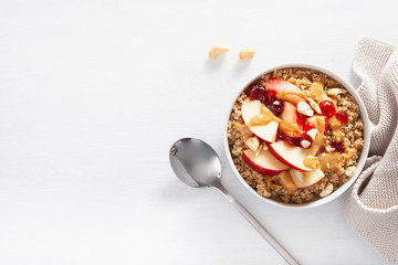 apple peanut butter quinoa bowl with jam and cashew for healthy breakfast