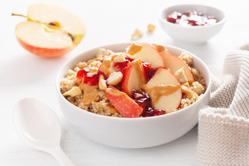 apple peanut butter quinoa bowl with jam and cashew for healthy breakfast