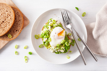 breakfast avocado sandwich with poached egg and feta cheese