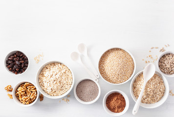variaty of raw cereals and nuts for breakfast. Oatmeal flakes and steel cut, barley, walnut, chia, raisins. Healthy ingredients