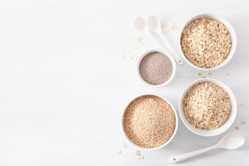 variaty of raw cereals for breakfast. Oatmeal flakes and steel cut, barley, chia seed. Healthy ingredients