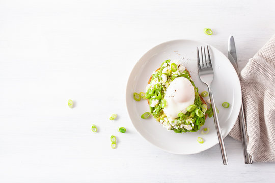 breakfast avocado sandwich with poached egg and feta cheese