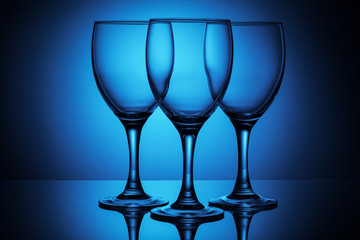 three empty glasses on a blue backgrounde