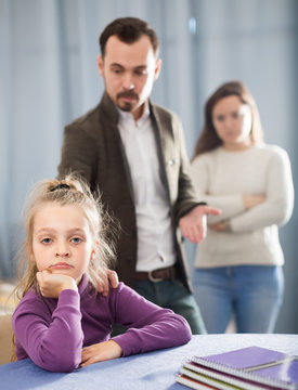 Ordinary parents lecturing girl for bad behavior