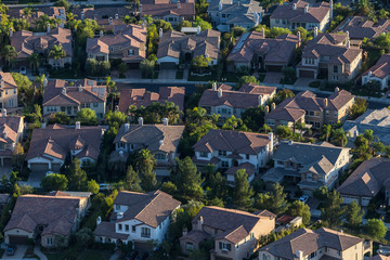 Later afternoon aerial view of modern hillside housing in the Porter Ranch area of Los Angeles, California. - obrazy, fototapety, plakaty
