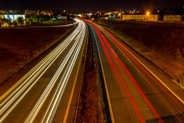 Car Light's Trail at Night, on a City Background