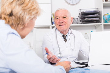 Fototapeta premium Male doctor with female client
