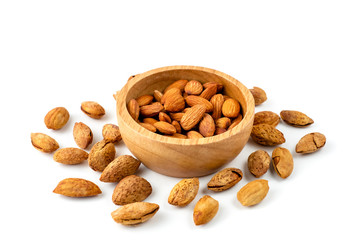 Close up of almonds nut seeds isolated in wooden bowl against on white background and clipping path.