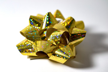 Sparkling gold bow on top side view on white background