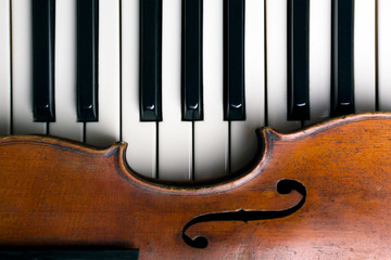 old violin on piano keys