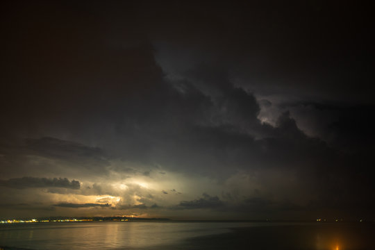 Thunderstorm over the sea, lightning beats the water