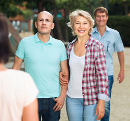 Couples of mature males and females walking on holiday