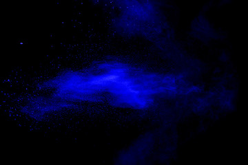 blue powder explode cloud on black background. Launchedblue dust particles splash on  background.