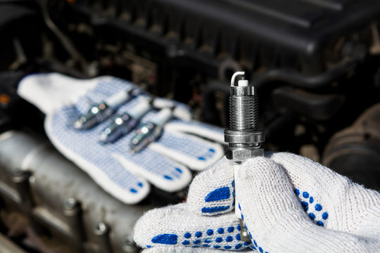 car candle in hand on engine background