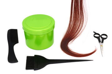 a strand of red hair, brushes, scissors, comb and container with hair dye, hairdressing tools on a white background, isolated