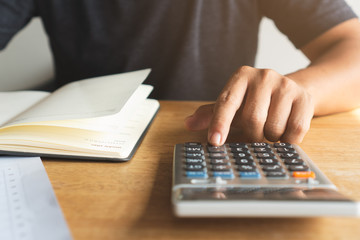 Close up hands of person using calculator prepare for annual tax.