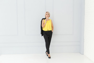 Fototapeta na wymiar Fashion portrait of woman in yellow and black suit
