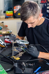 professional electronic technician repairing equipment in a service center