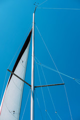 Sail of a sailing boat against blue sky