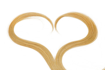 a strand of blond hair in the shape of a heart on a white background, isolated