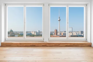 Fototapeten view on Berlin skyline and tv tower through  terrace window in modern apartment room © hanohiki