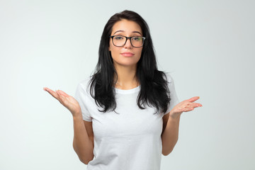 pleasant Caucasian woman in white T-shirt explaining something with gesture. close up photo.