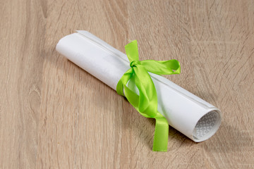Closed paper screw with green ribbon