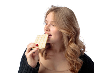 Happy young beautiful woman eating white chocolate.