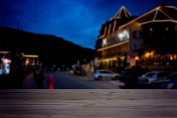empty table on the night view of street in city background