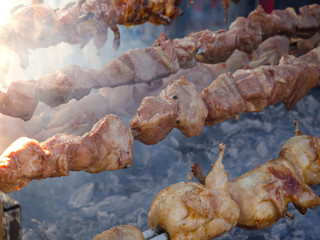 Meat is fried on a spit. Street food grill.