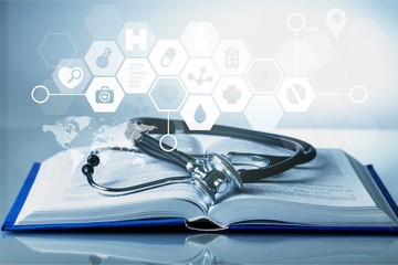 Stethoscope object and book  on backgrouund