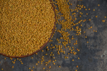 Fenugreek Seeds isolated on texture background.