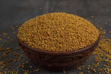 Fenugreek Seeds isolated on texture background.