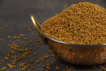 Fenugreek Seeds isolated on texture background.