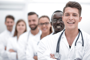 Team of smiling professional doctors standing together