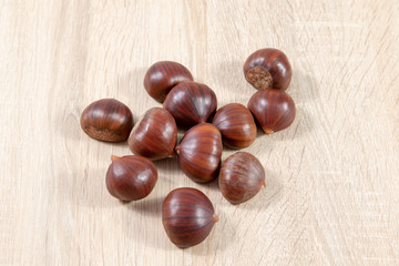 top view on chestnuts on wooden background