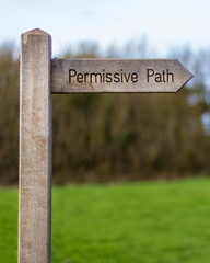 A wood trail sign points the way of the 