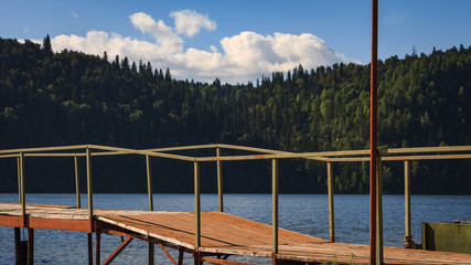 Wooden pier, bridge on a Sunny summer day on the river