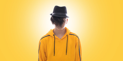 young fashioned teenager isolated in yellow background