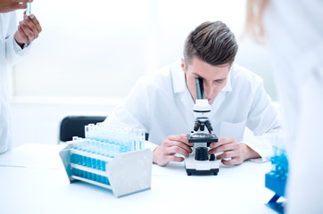 Serious clinicians studying chemical elements in laboratory